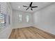 Bright bedroom with plantation shutters, a ceiling fan, and light wood flooring at 4379 Bella Cascada St, Las Vegas, NV 89135