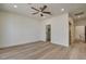 Cozy bedroom featuring hard wood floors, neutral color palette, a ceiling fan, and a closet with sliding mirror doors at 4379 Bella Cascada St, Las Vegas, NV 89135