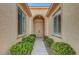 Charming front entrance with double doors, lush landscaping, and sidelight windows at 4379 Bella Cascada St, Las Vegas, NV 89135