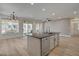 Bright kitchen featuring a center island with sink, stainless steel appliances, and backyard views at 4379 Bella Cascada St, Las Vegas, NV 89135