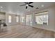 Bright, open living area with backyard views, a ceiling fan, and an adjacent kitchen area at 4379 Bella Cascada St, Las Vegas, NV 89135