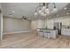 Open living space featuring a kitchen island with bar stools, and light wood flooring at 4379 Bella Cascada St, Las Vegas, NV 89135