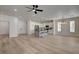 Open-concept floor plan featuring a modern kitchen, living area, and wood-look flooring at 4379 Bella Cascada St, Las Vegas, NV 89135