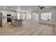 Open-concept living area featuring wood flooring, a ceiling fan, and sliding doors to the backyard at 4379 Bella Cascada St, Las Vegas, NV 89135