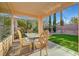 Cozy covered patio with table and chairs overlooking a well-maintained backyard at 4379 Bella Cascada St, Las Vegas, NV 89135