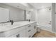Modern bathroom featuring double sinks, marble countertops, and a full-size mirror at 4405 Pioche Ave, North Las Vegas, NV 89032