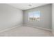 A bright and airy bedroom with carpet flooring, a window, and a serene atmosphere at 4405 Pioche Ave, North Las Vegas, NV 89032
