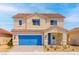 Charming two-story home with a blue garage door and a well-manicured front yard on a sunny day at 4405 Pioche Ave, North Las Vegas, NV 89032