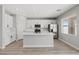 Modern kitchen with white cabinets, stainless steel appliances, and a center island with marble countertop at 4405 Pioche Ave, North Las Vegas, NV 89032
