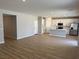 Open-concept living room and kitchen with modern white cabinets, stainless appliances, and wood-look floors at 4405 Pioche Ave, North Las Vegas, NV 89032