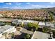 A picturesque aerial view of a residential area with red-tiled roofs and lush trees at 5096 Thunder River Cir, Las Vegas, NV 89148