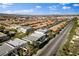 Expansive aerial view of a neighborhood with tree-lined streets and mountain views at 5096 Thunder River Cir, Las Vegas, NV 89148