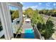 Stylish backyard with plunge pool, umbrella-shaded patio seating, and tall windows offering views of lush landscaping at 5096 Thunder River Cir, Las Vegas, NV 89148