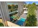 Stylish backyard with plunge pool, umbrella-shaded patio seating, and tall windows offering views of lush landscaping at 5096 Thunder River Cir, Las Vegas, NV 89148