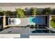 Bird's eye view of a modern backyard featuring a plunge pool, patio with umbrella, and well-manicured greenery at 5096 Thunder River Cir, Las Vegas, NV 89148