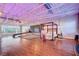 Modern, open bedroom with wood floors, metal ceiling structure and large windows at 5096 Thunder River Cir, Las Vegas, NV 89148
