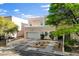 Attractive two-story house featuring a balcony, a two-car garage, and a tidy front yard at 5096 Thunder River Cir, Las Vegas, NV 89148