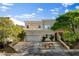 Elegant two-story home with a balcony, well-manicured landscaping, and a two-car garage at 5096 Thunder River Cir, Las Vegas, NV 89148