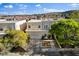 Elevated view of this home featuring a charming balcony, well-manicured lawn, and convenient two-car garage at 5096 Thunder River Cir, Las Vegas, NV 89148