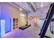 Bright home gym with ceiling mounted equipment, shelving, and padded floor at 5096 Thunder River Cir, Las Vegas, NV 89148
