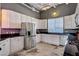 Stylish kitchen with white cabinets, black countertops, and stainless steel appliances, offering a modern look at 5096 Thunder River Cir, Las Vegas, NV 89148