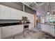 Contemporary kitchen with white cabinets, stainless appliances, and exposed ceiling, complemented by concrete floors at 5096 Thunder River Cir, Las Vegas, NV 89148