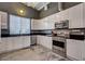 Bright kitchen featuring stainless steel appliances, white cabinets, and dark countertops for a sleek, modern look at 5096 Thunder River Cir, Las Vegas, NV 89148