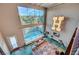 Bright, modern living room with a high ceiling, large windows, pool view, and unique decorative lighting at 5096 Thunder River Cir, Las Vegas, NV 89148