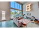 Bright living room with soaring ceilings, large windows and an open floor plan; great for entertaining at 5096 Thunder River Cir, Las Vegas, NV 89148