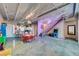 Open living space featuring exposed ceiling beams, concrete floors, kitchen, and a playful, modern design at 5096 Thunder River Cir, Las Vegas, NV 89148