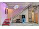 Modern industrial stairway with red steps and metal railing leading to an arcade game, adding unique charm at 5096 Thunder River Cir, Las Vegas, NV 89148