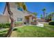 The backyard has a covered patio and a built-in outdoor grill, landscaping and green grass at 5405 Ireland St, Las Vegas, NV 89149