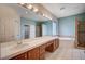 Bathroom featuring double sinks, a large mirror, and a separate tub and shower at 5405 Ireland St, Las Vegas, NV 89149