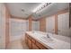 Bathroom with a dual sink vanity, shower and bath with glass doors, and a large mirror at 5405 Ireland St, Las Vegas, NV 89149