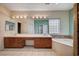 A bathroom featuring a dual sink vanity, tiled floors, and a separate soaking tub at 5405 Ireland St, Las Vegas, NV 89149