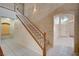 Staircase to the second floor with carpeted steps and a decorative archway in the background at 5405 Ireland St, Las Vegas, NV 89149