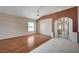 Spacious living room with wood floors, a ceiling fan, and an open archway at 5405 Ireland St, Las Vegas, NV 89149