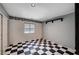 An open room with a black and white checkered tile floor, recessed lighting, and minimalist decor at 5405 Ireland St, Las Vegas, NV 89149