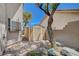A backyard shed on a lot with rocks and stepping stones and mature trees around the perimeter at 5405 Ireland St, Las Vegas, NV 89149