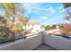 Balcony view of neighborhood with landscaping, houses, and blue sky at 5710 E Tropicana Ave # 2122, Las Vegas, NV 89122