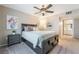 Comfortable bedroom featuring a ceiling fan, carpet, and a doorway to an ensuite bathroom at 5710 E Tropicana Ave # 2122, Las Vegas, NV 89122