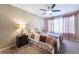 Comfortable bedroom with soft lighting, ceiling fan, and inviting decor elements at 5710 E Tropicana Ave # 2122, Las Vegas, NV 89122