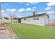 Expansive backyard with artificial turf, covered patio and low maintenance landscaping at 6437 Burgundy Way, Las Vegas, NV 89107