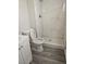 Remodeled bathroom featuring a tiled shower, modern vanity and gray plank flooring at 6437 Burgundy Way, Las Vegas, NV 89107