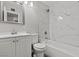Renovated bathroom featuring modern fixtures, a vanity, and marble tile shower and tub at 6437 Burgundy Way, Las Vegas, NV 89107