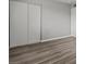 Spacious bedroom features large closet doors and gray plank flooring at 6437 Burgundy Way, Las Vegas, NV 89107