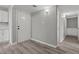 Welcoming entryway with light grey walls and attractive grey wood-look floors, and white cabinets at 6437 Burgundy Way, Las Vegas, NV 89107