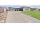 Charming single-story home with black and white accents, a driveway, and a well-manicured lawn at 6437 Burgundy Way, Las Vegas, NV 89107