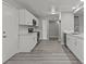 Modern kitchen with white cabinets, stainless steel appliances, and quartz countertops at 6437 Burgundy Way, Las Vegas, NV 89107