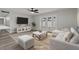 Bright living room featuring a ceiling fan, TV, sofa, and French doors leading to the yard at 6437 Burgundy Way, Las Vegas, NV 89107